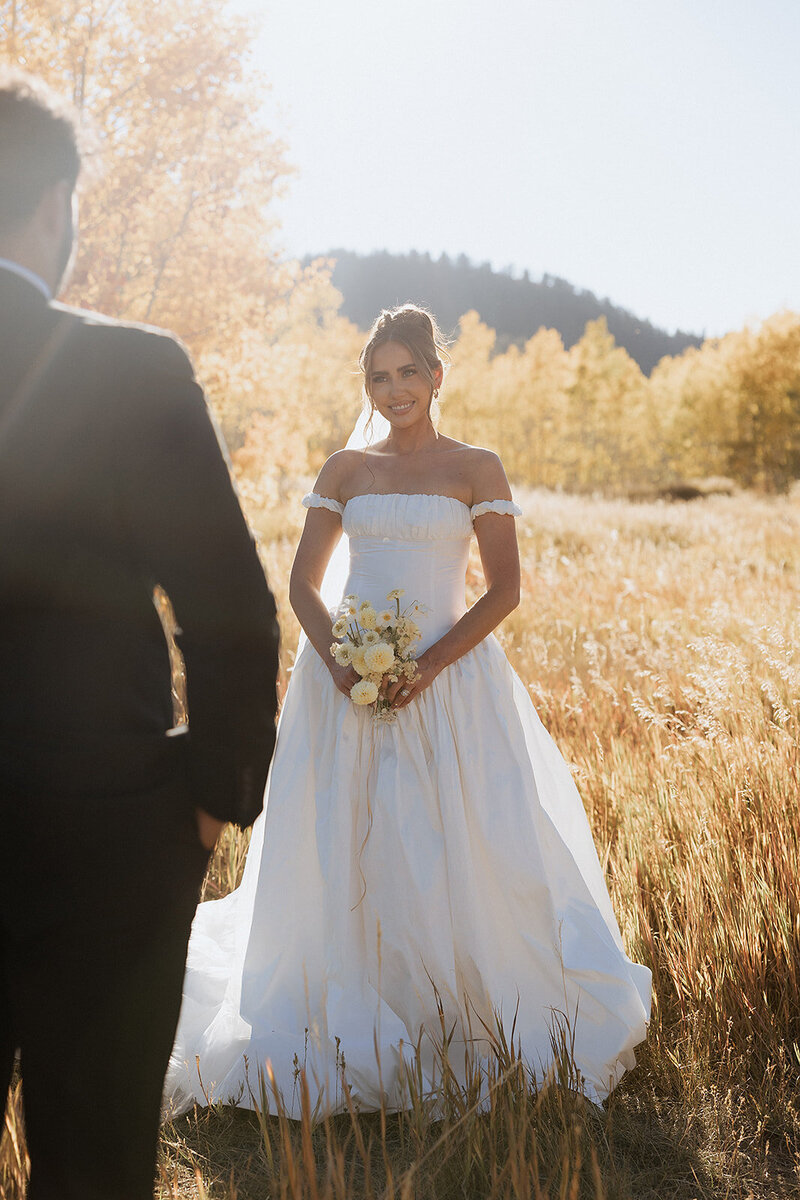 Couple walking hand and hand with their daughter at their elopement in the Utah Mountains. 