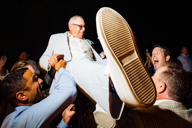 Father of the Bride being lifted in the air during the reception as the groom screams in joy