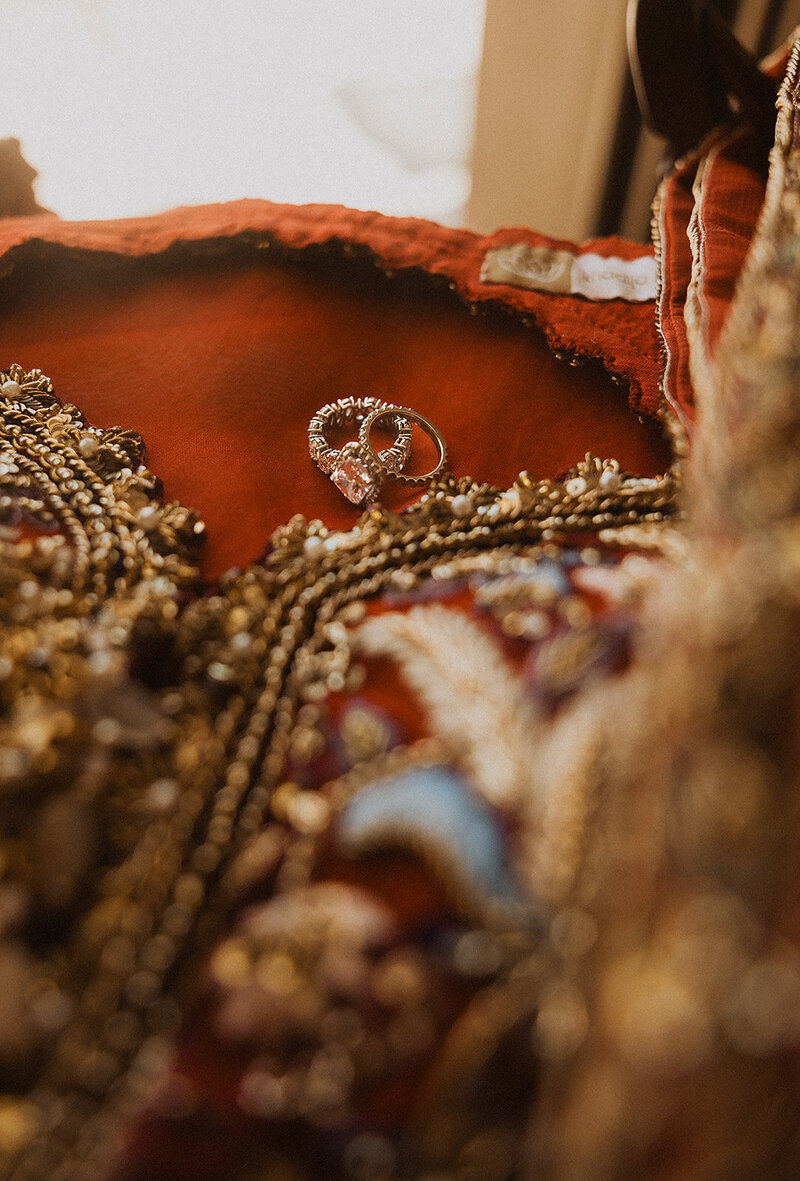 Detail shot of colorful dress with wedding rings