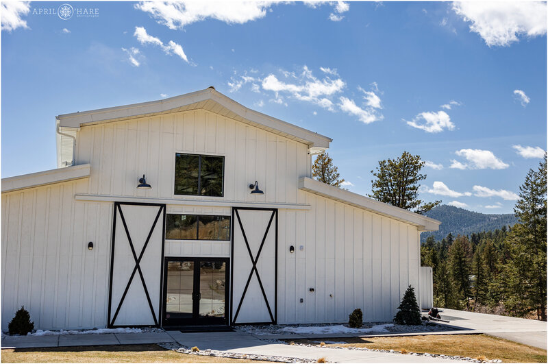 Exterior of Woodlands Wedding Venue Barn on a bright sunny day in Colorado