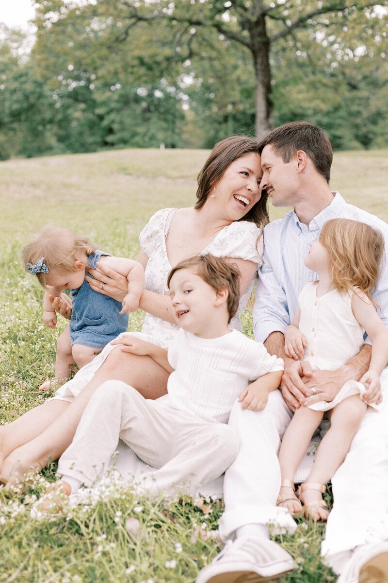 Family sitting and playing outside for photos in peoria, illinois
