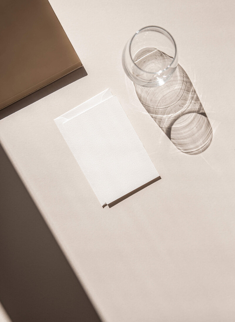Stock photos that can be customized like this blank piece of paper and glass of water