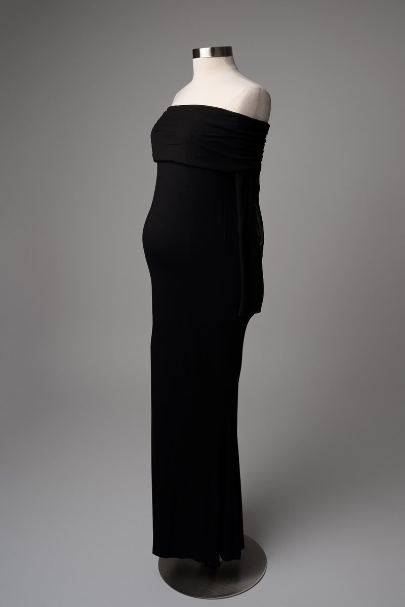 Strapless black velvet gown styled on mannequin with classic silhouette