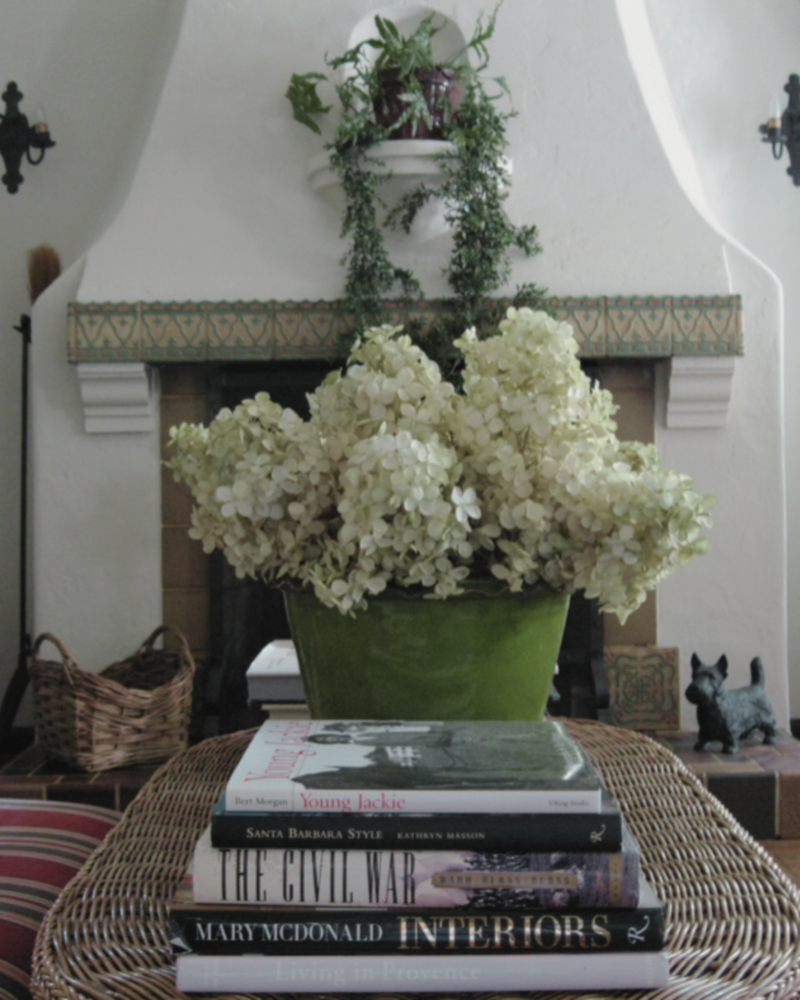 Shiree Segerstrom Design Spanish style fireplace with vintage tiles and chartreuse hydrangeas
