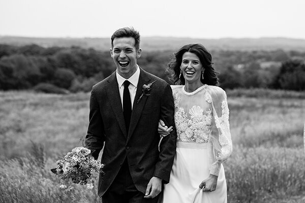 happy bride and groom walking arms linked for an unposed organic wedding photography in london
