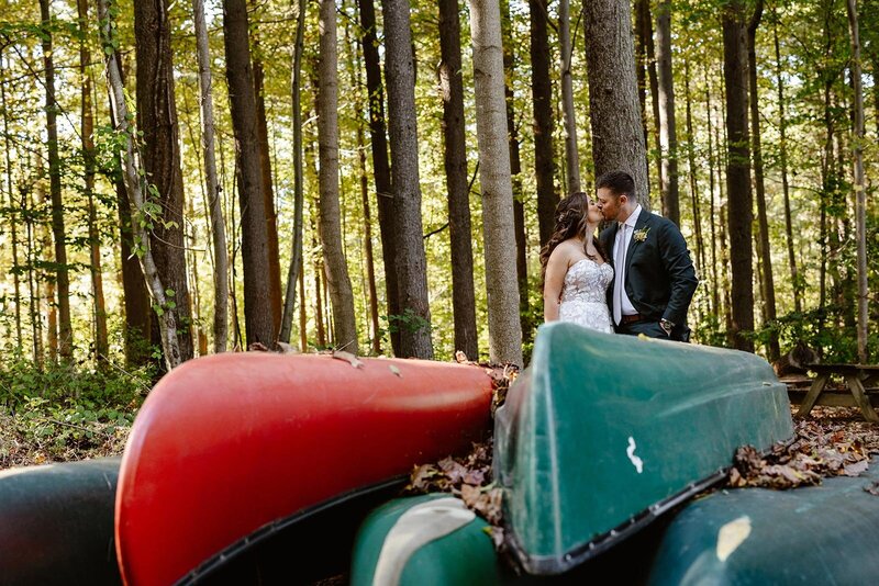 A couple smiles at one another during a snowy hiking elopement.