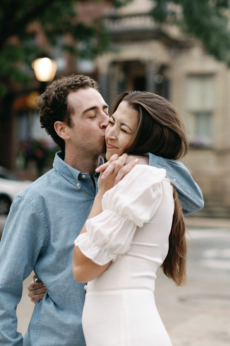 A couple embraces during their city inspired engagement session in Wilmington North Carolina