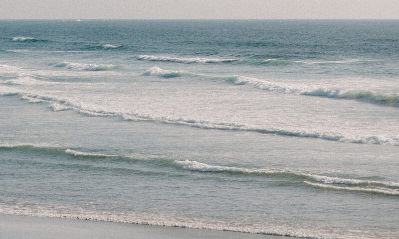 Rolling turquoise waves of the Caribbean Sea crash along the Tulum coastline.