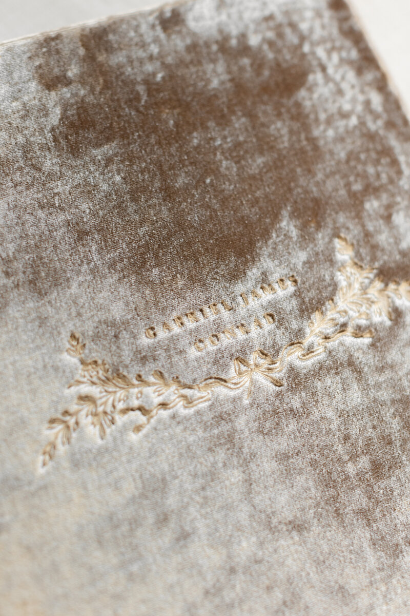 A closeup of blind debossing on a velvet album by Newborn Photographer Washington DC