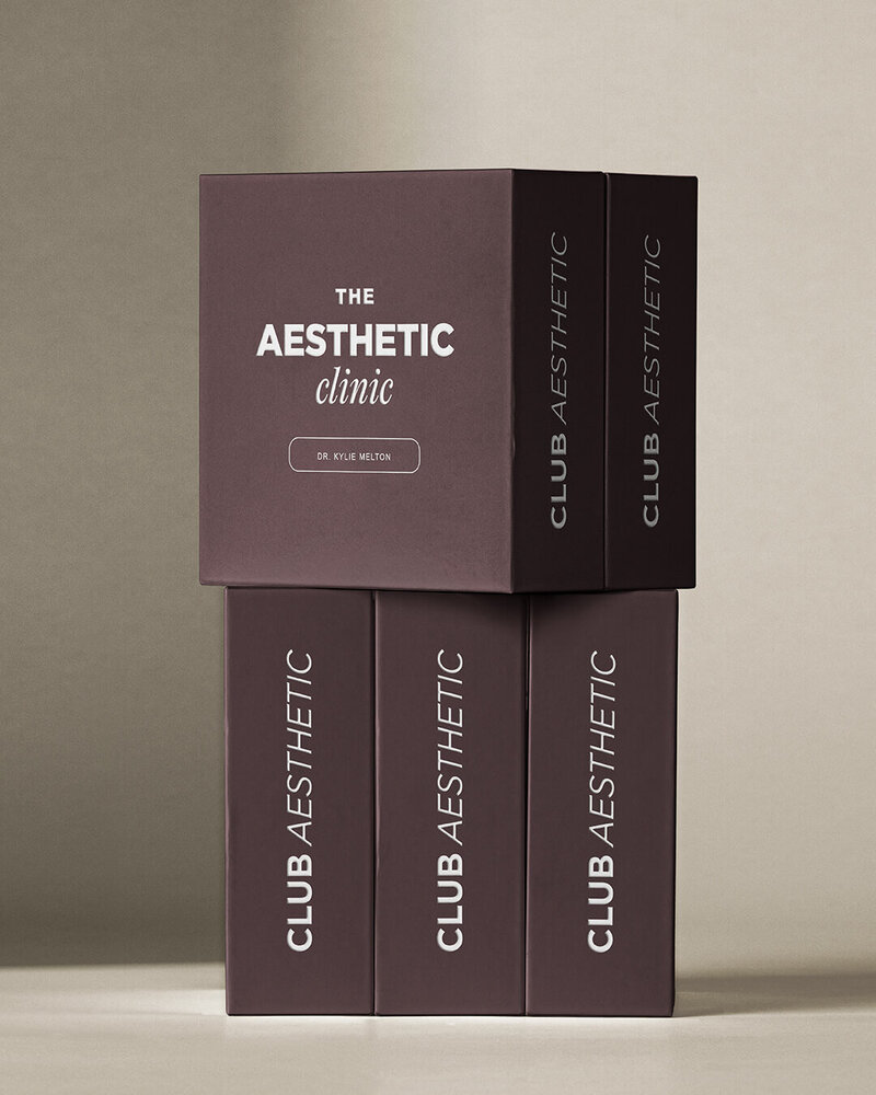 Stack of Purple Boxes that say The Aesthetic Clinic