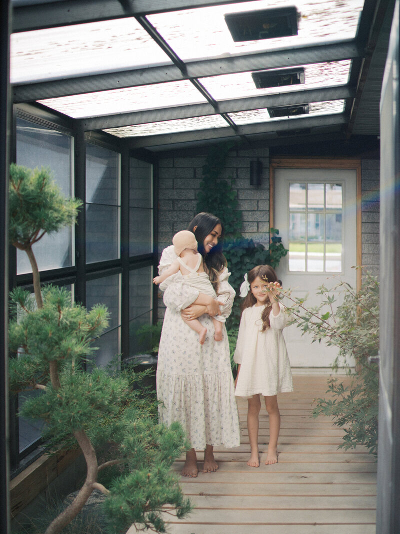 Mom and her daughters standing for family pictures