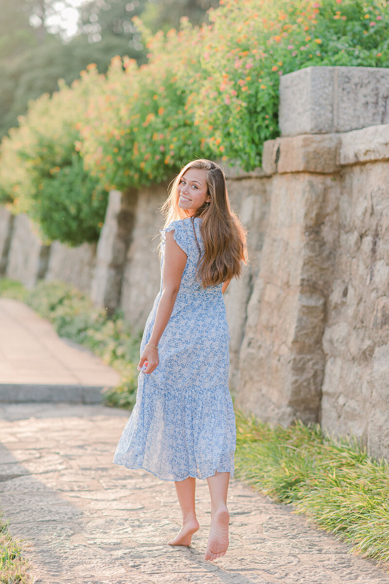 girl walking on a path in a blue dress