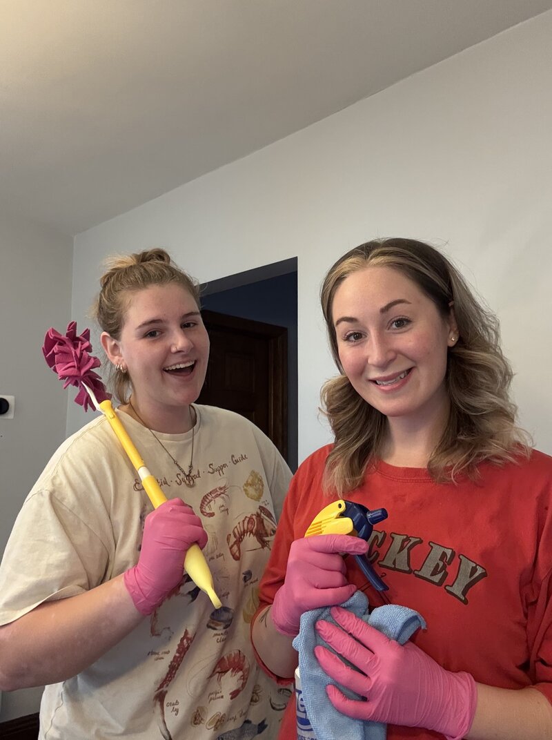 Two home cleaning business owners celebrating another cleaning job well done