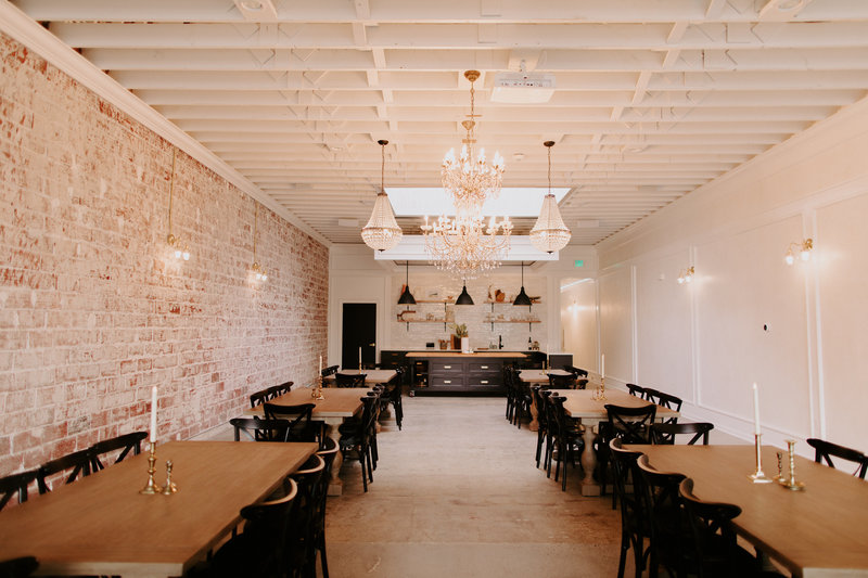Interior of our studio with tables, chairs, and candles.
