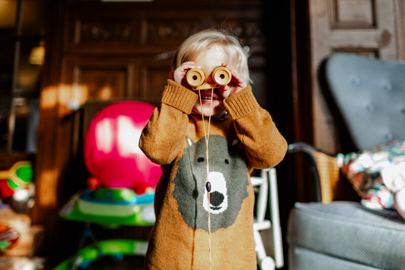 A boy playing  with a toy binocular