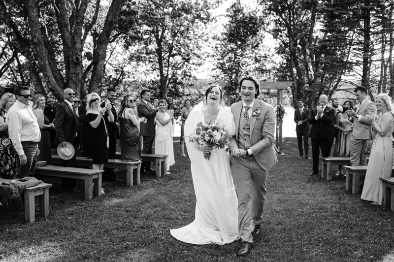 Newlyweds leaving ceremony designed by Nova Scotia Wedding Planner, Love Nest.