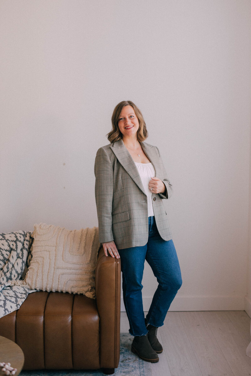 Katie, owner of Modern Mollusk, professional home stager serving Snohomish and North King County, sitting in a cozy styled room.