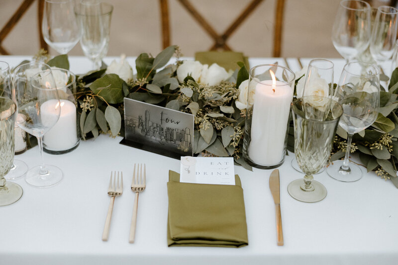 wedding reception table with table number, candles and menu
