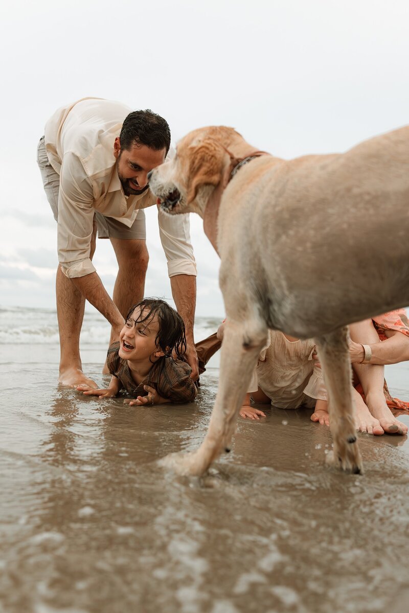 San Antonio Family playing on the beach with a dog