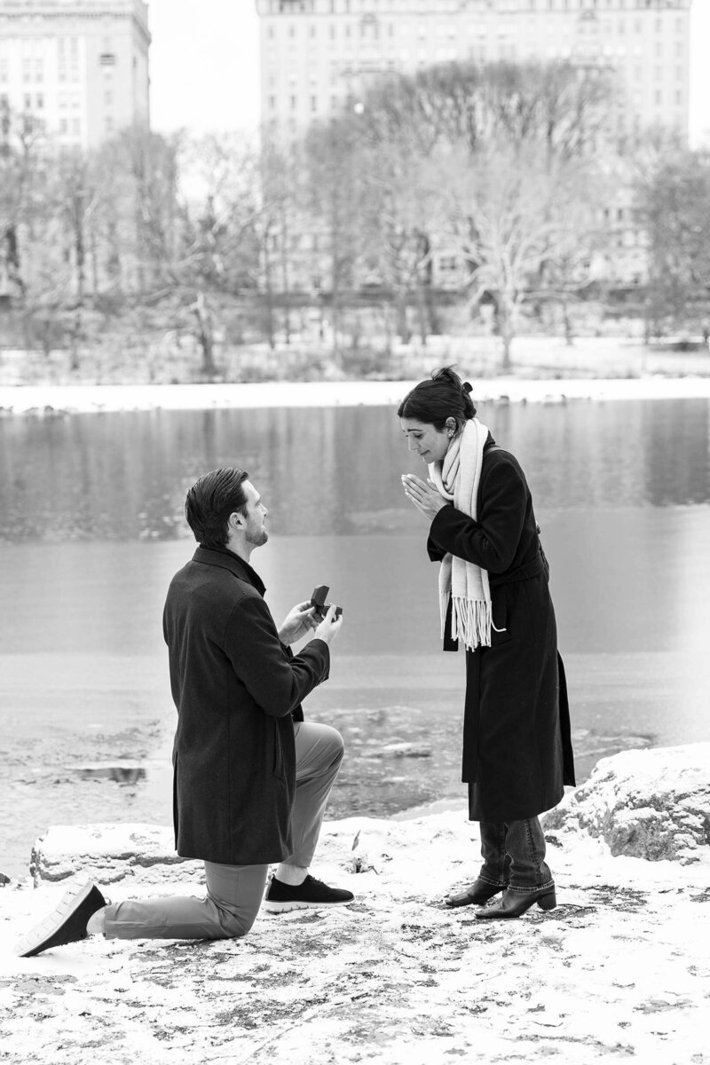 Winter-snow covered ground-Surprise proposal moment by the Lake at Central Park.