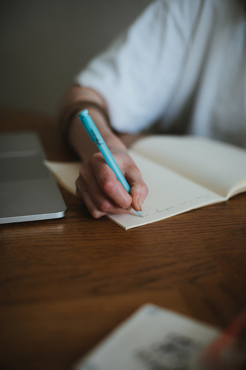 Copywriter takes notes in her home office in Oxfordshire
