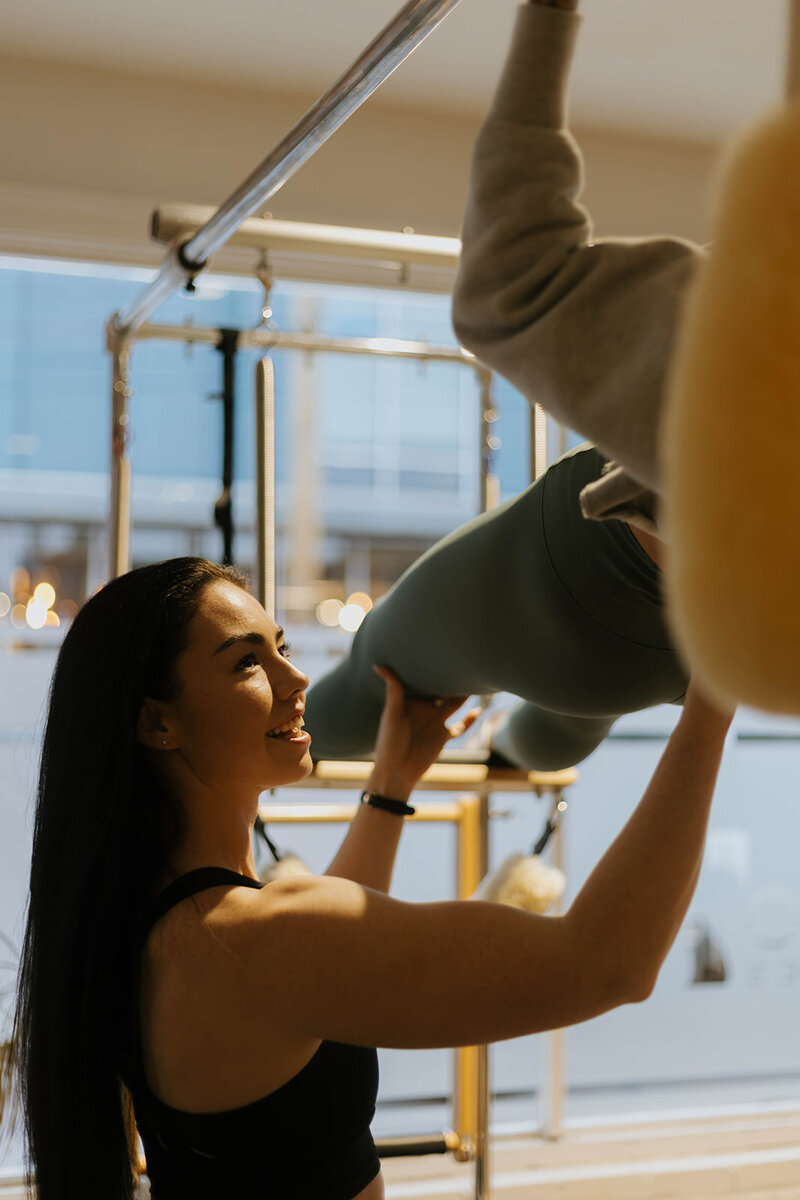 Makeilee helping a private client with pullups 