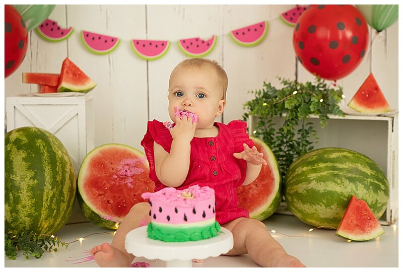 one year old girl eating watermelon cake