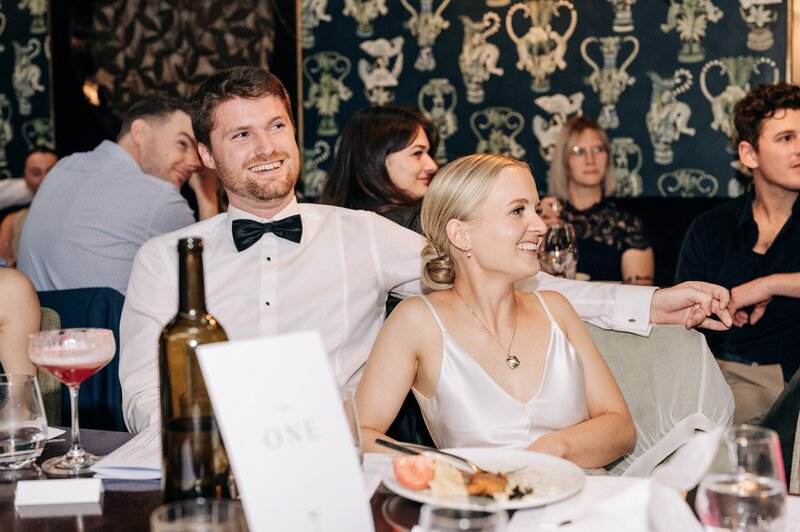 bride and groom laugh during wedding reception speeches at 5th street restaurant christchurch