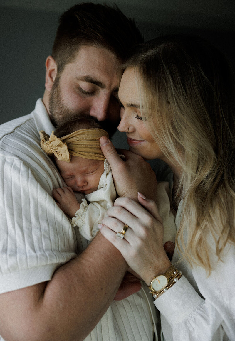 detail photo of a couple holding their newborn baby