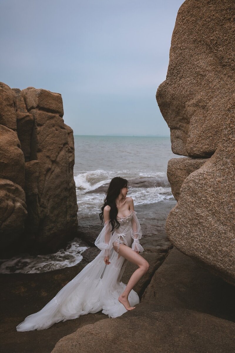 A beautiful windswept beach couture shoot amongst coastal rocks.