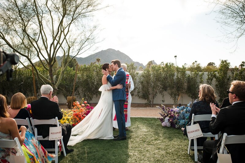 bride and groom first kiss at wedding ceremony