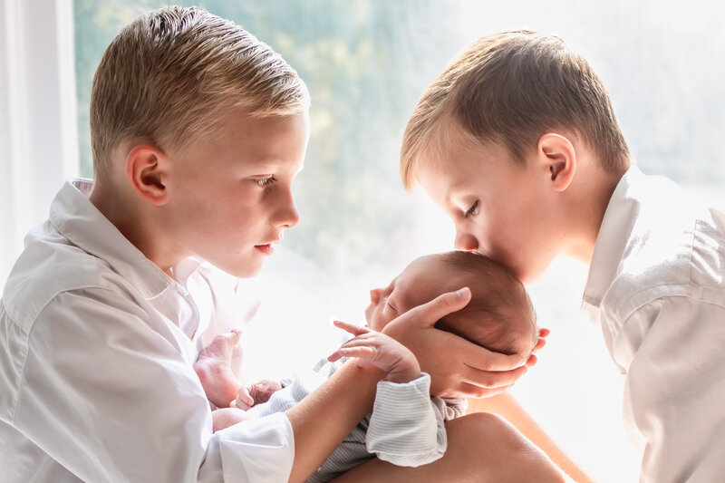 A mother's hands on her pregnant belly.