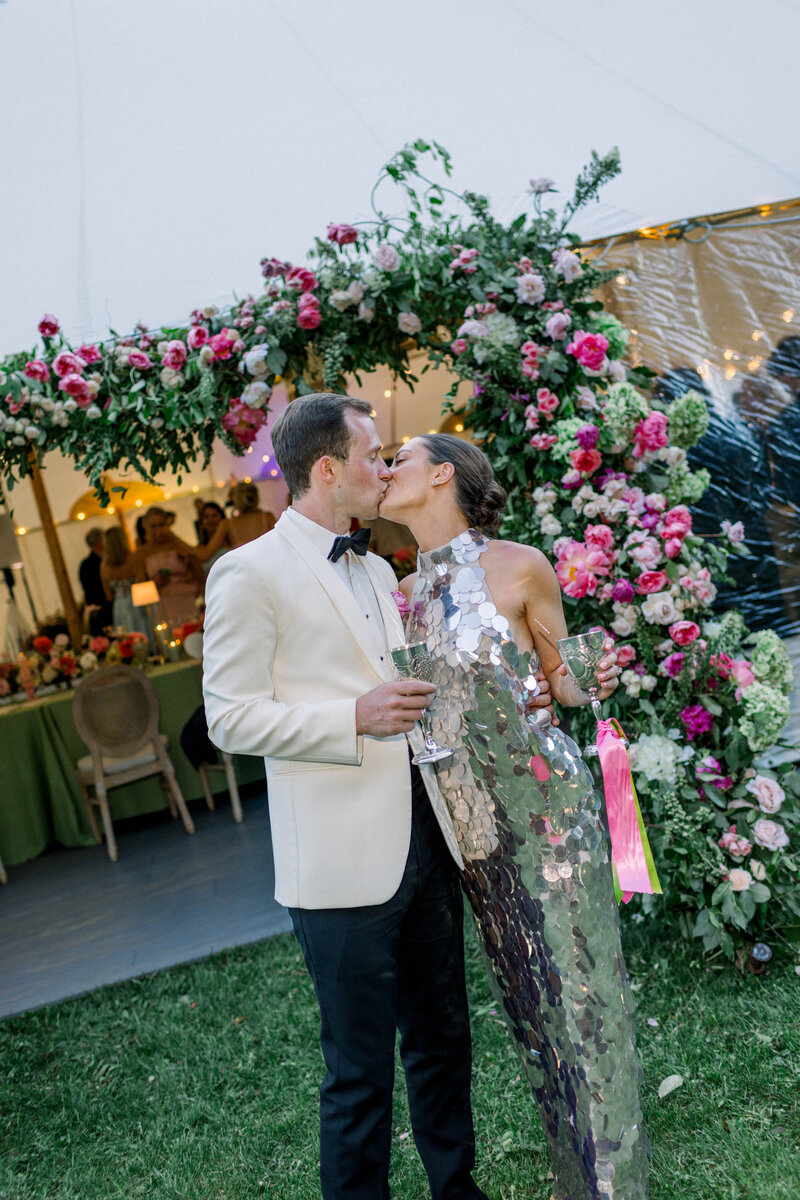 man and woman standing with their backs to each other next to large marble pillars