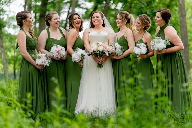Bride and bridesmaid wearing green in a forest