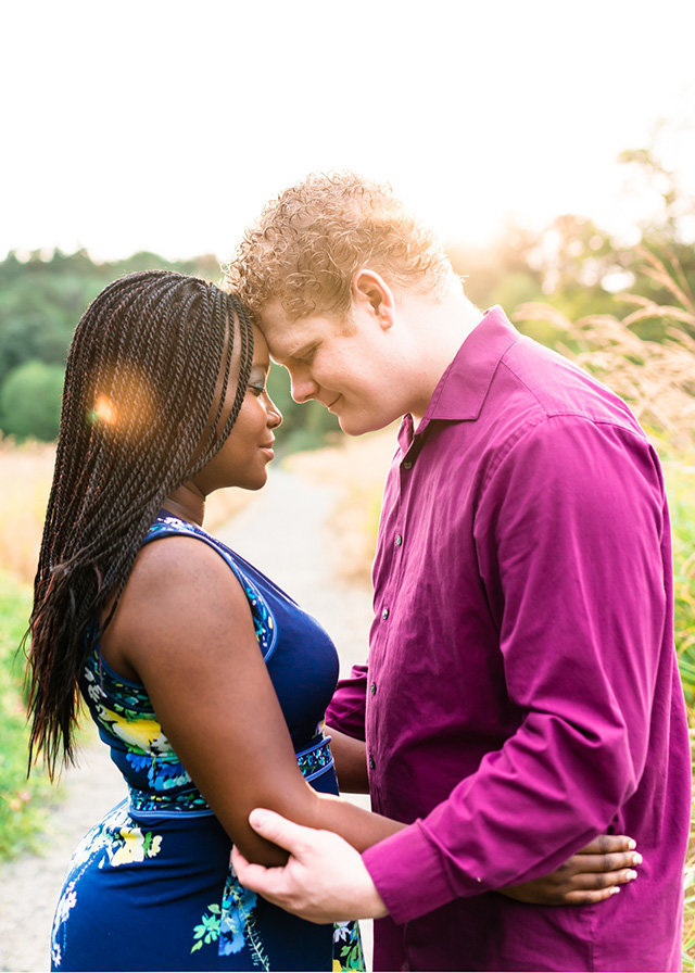 inter-racial couple in field with foreheads touching Bob Heirman Wildlife Area Snohomish | Meg Sivakumar Photography