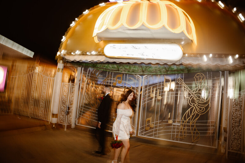 Couple posing outside the Little White Wedding Chapel during their Las Vegas elopement.