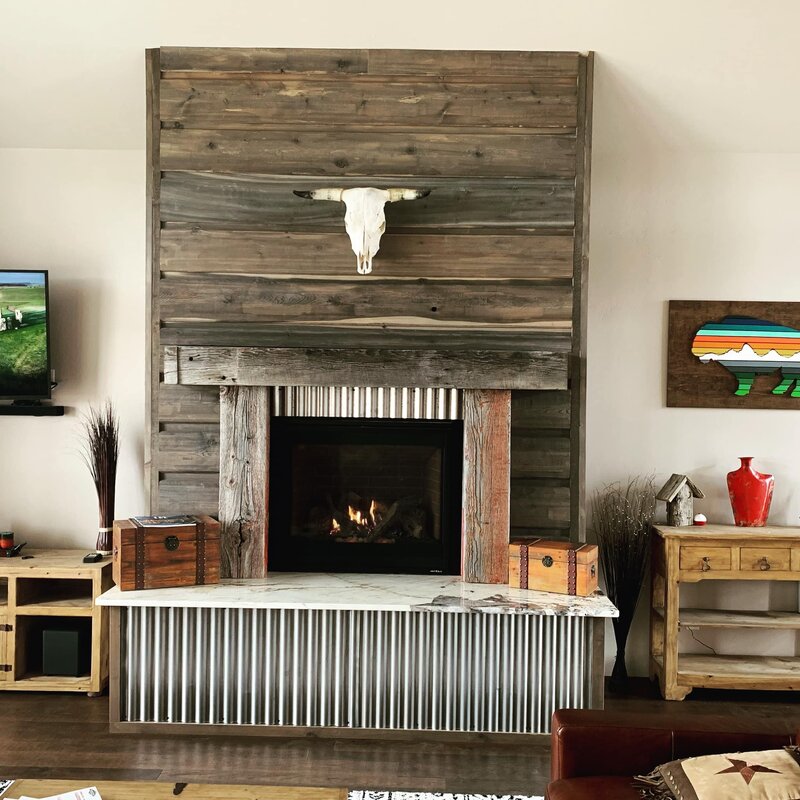 Custom Fireplace with reclaimed barnwood and corrugated metal adorned with a bison skull
