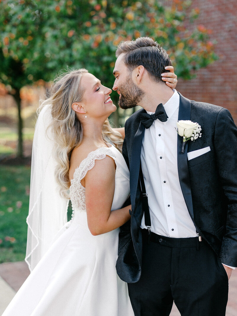 Bride pulls groom close to her for a kiss