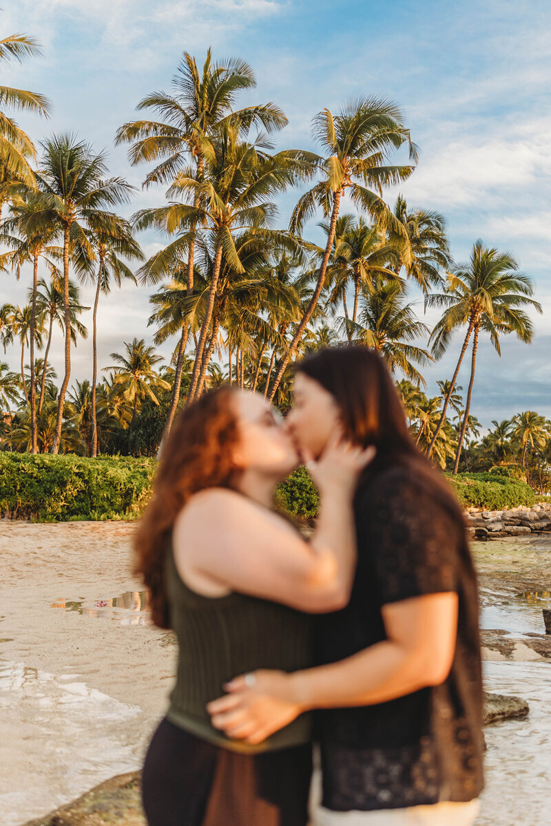 Same sex couple hugging in Hawaii beach