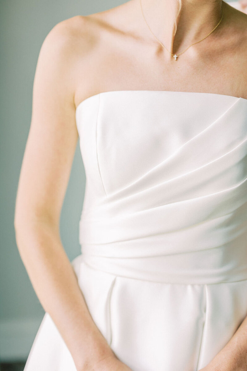 Bride stands in elegant white dress