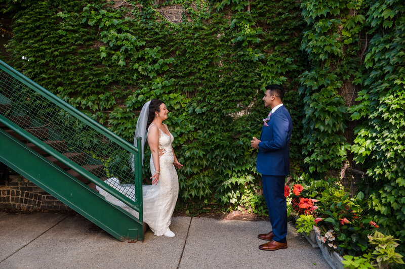 Bride and groom first look in front of Ivy wall