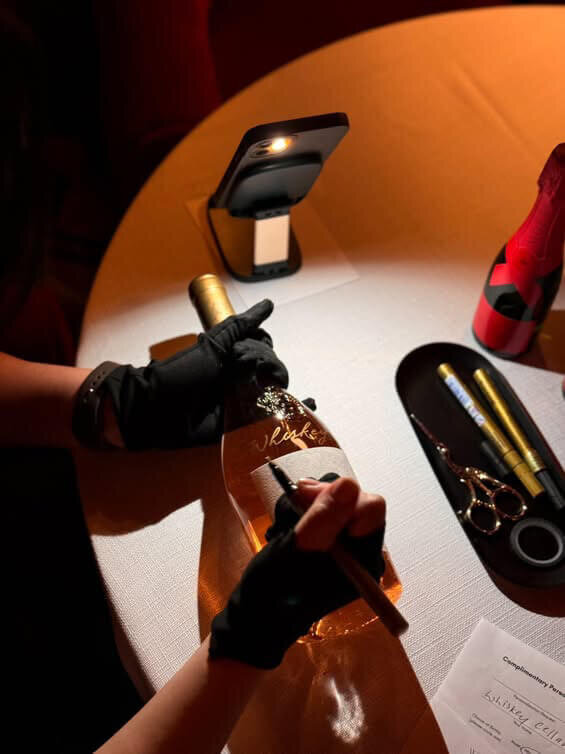 Calligrapher engraving mote bottle