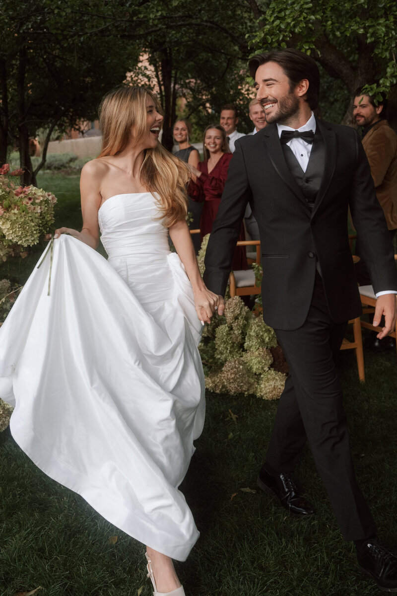 Bride and groom walking back down the aisle 