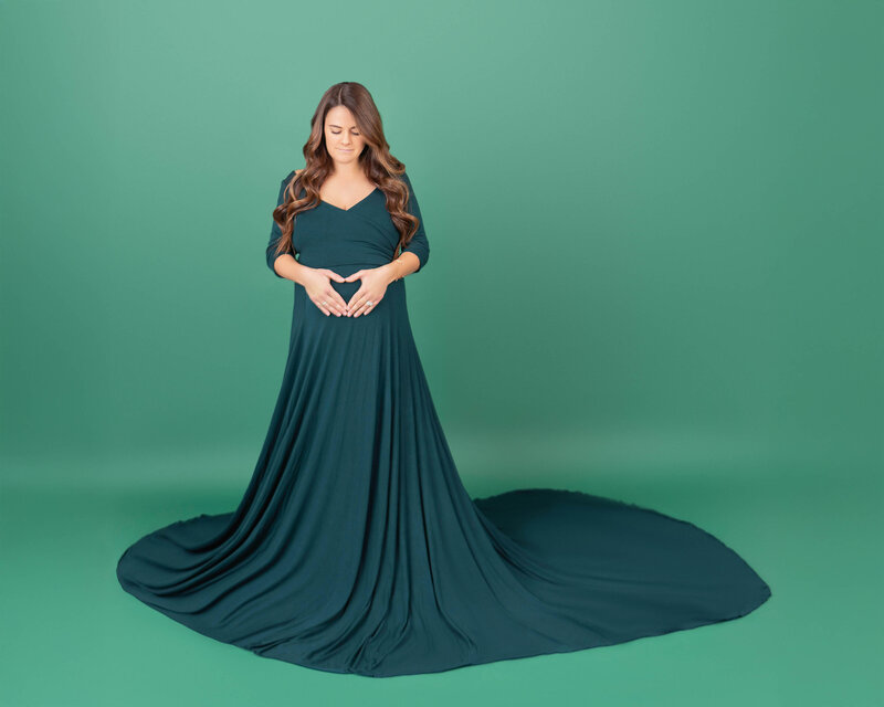 Pregnant women in red dress in studio by Diane Gabriel photography