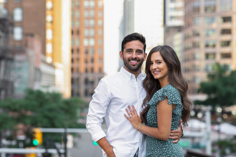 Engaged couple smiling on rooftop