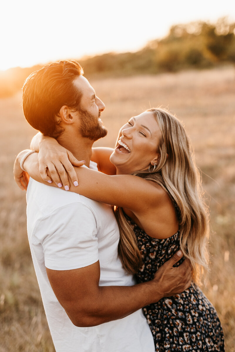 Sunny warm engagement photo of couple laughing hysterically - Alex Bo Photo