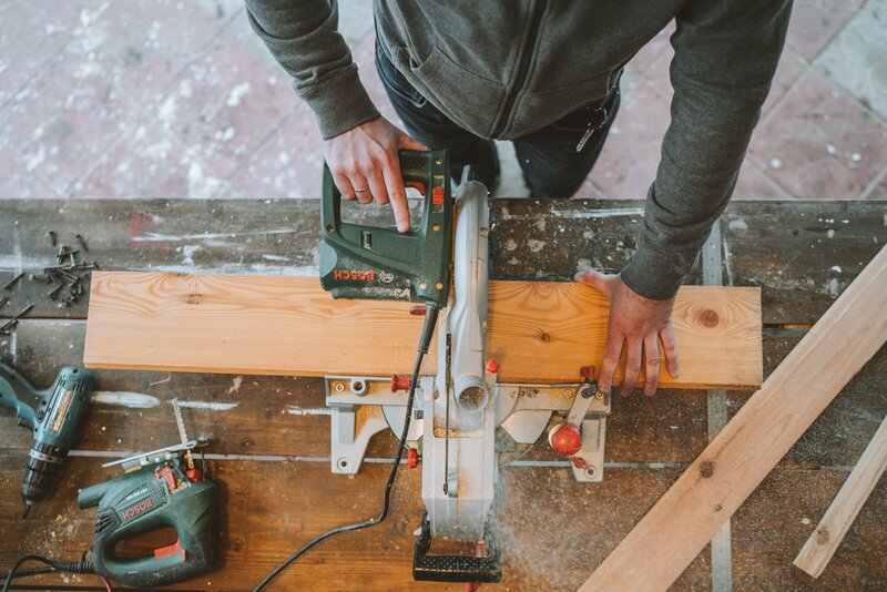 Man using a saw to cut wood for home project