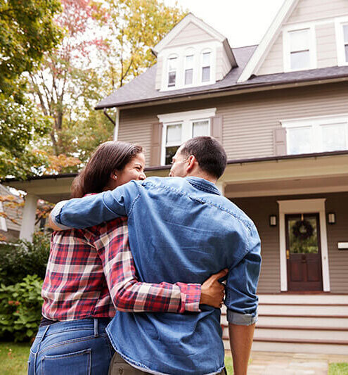 Couple in Front of Home Brookline MA Relator Noha Soliman Crafted Path Home