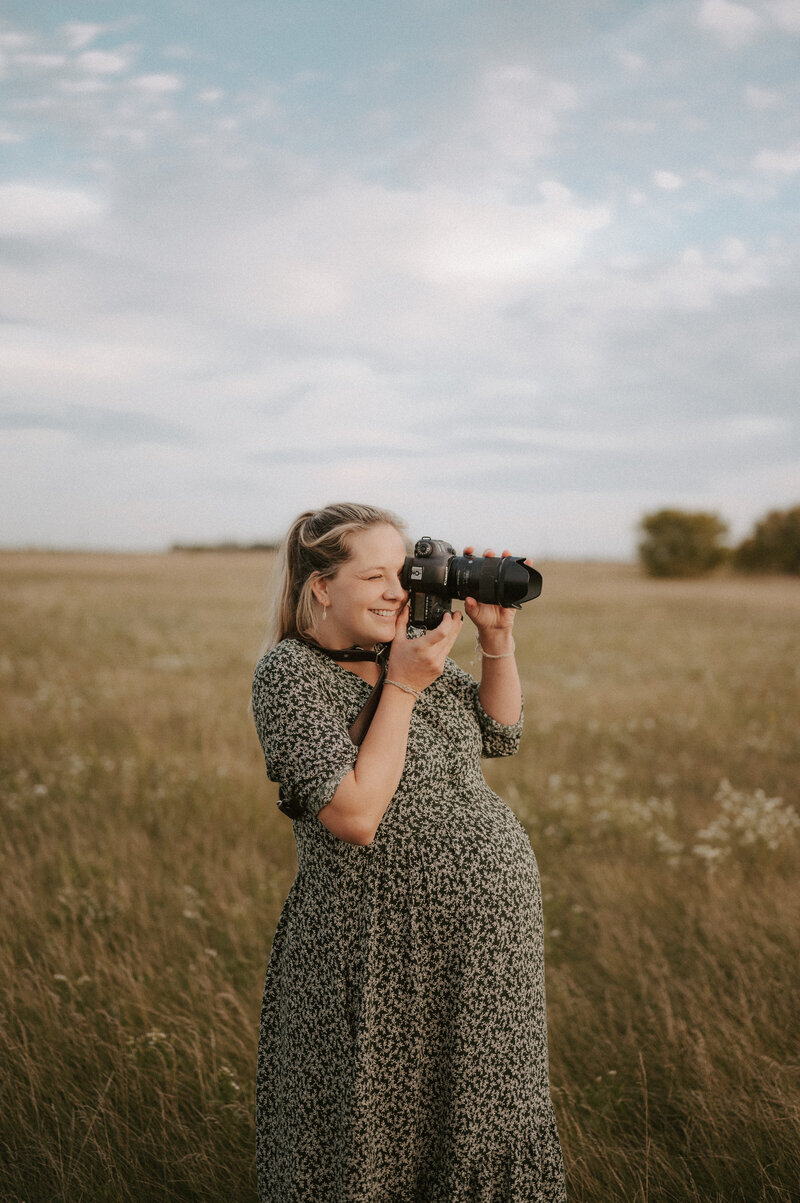 pregnant mother holding camera