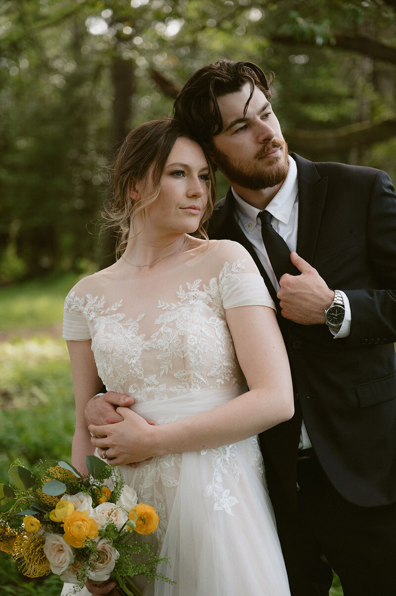 the couple cuddled by the mountains